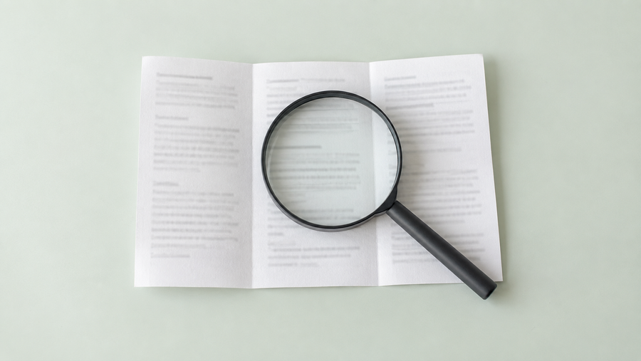 A magnifying glass over a supplement ingredient leaflet